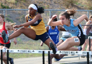 Sophomore clears a hurdle during the 100-meter hurdle race. She placed first out of 32 runners during Friday Night Lights with a time of 15.28 seconds.