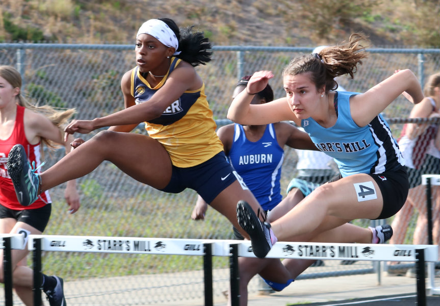 Sophomore clears a hurdle during the 100-meter hurdle race. She placed first out of 32 runners during Friday Night Lights with a time of 15.28 seconds.