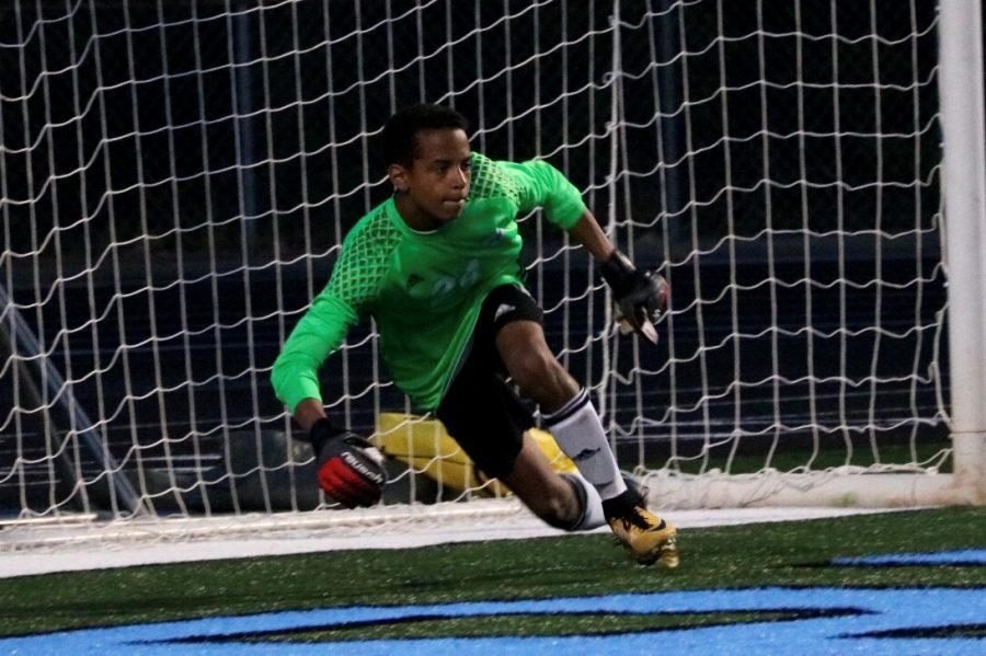 Freshman keeper Andrew Cole saves the ball as it is shot his way. “I try to organize [the team] as much as I can and tell them where to be,” Cole said. “I always have the best view of the field.”