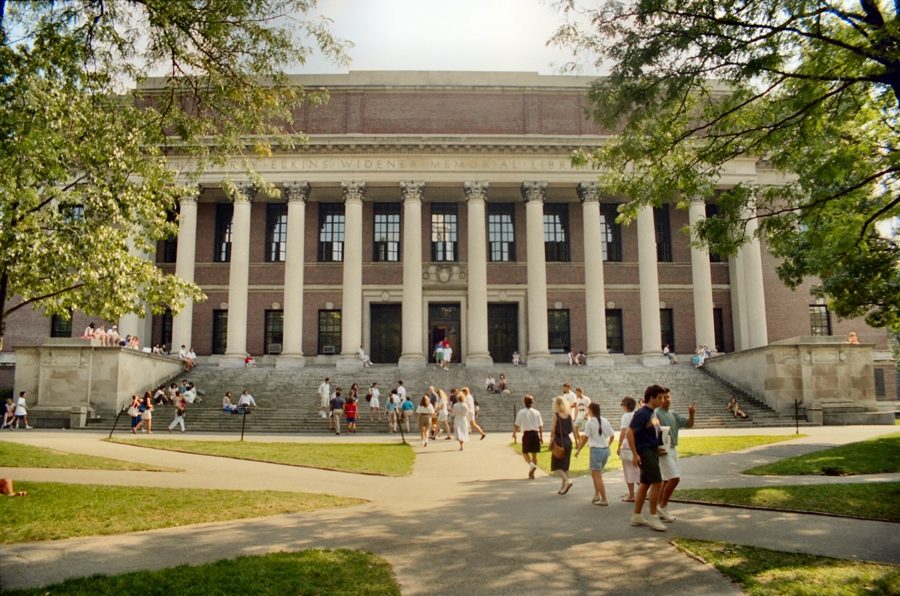 Students walk on Harvard University’s campus in Cambridge, Mass. While the prestige of certain colleges may be attractive to prospective students, there are more important factors, such as the quality of academics and personal fit, that should be considered before applying to them.