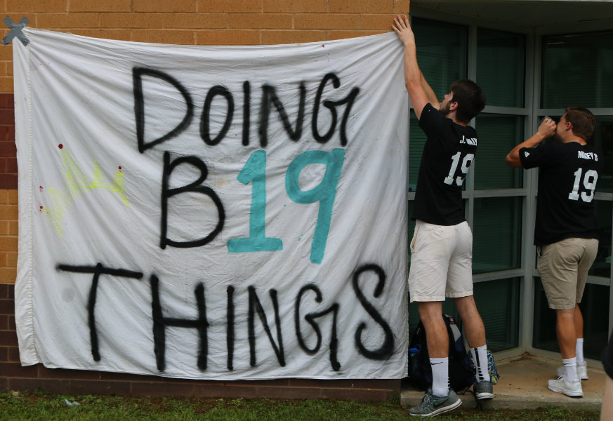 May 18, 2018 - Juniors Jack Wilson and Michael Burnett hang a banner at the Class of 2019’s senior tailgate. This tailgate is an annual ritual where the rising seniors wear their seniors shirts and socialize the day after the Senior Walk. 