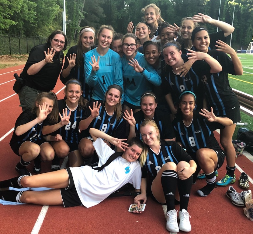 Lady Panthers hold up four fingers signifying the team advancing to the AAAAA Final Four after their 1-1 (6-5) victory over Chamblee. The Mill plays intercounty rival Whitewater at home tomorrow at 6 p.m. for a shot at the state championship. In the last matchup against Whitewater, Starrs Mill defeated the Wildcats in penalty kicks. 