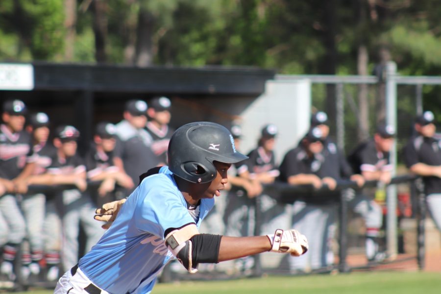 Starr’s Mill player takes off from home plate after hitting the ball. The Panthers’ spectacular hitting was a major factor in their 7-0 game one victory.