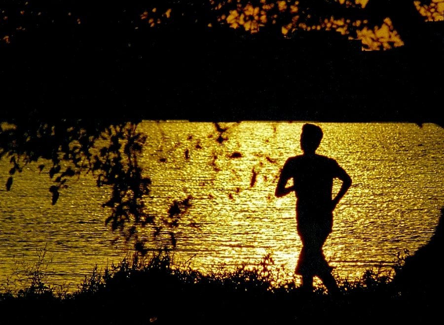 Man goes on an evening jog. While most individuals run to gain physical strength, running on a regular basis can also improve our mental health and teach us the value of hard work.