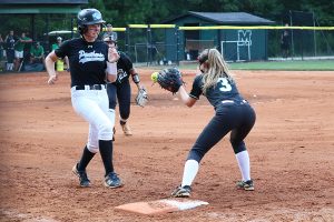 Junior Paige Andrews races to first base while Sophomore Chief Rebecca Muh attempts to throw her out. Muh and freshman Lady Panther Lilli Backes battled on the mound, but the Starr’s Mill offense came through in the 3-0 win. 