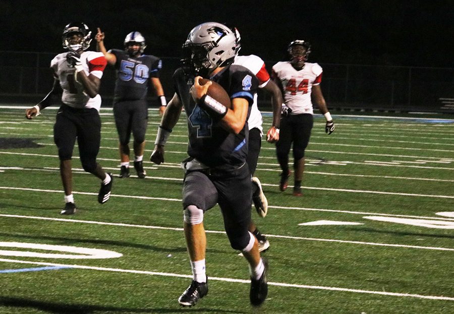 Junior quarterback Hunter Lawson races past the Bulldog defense. Lawson collected 129 of the Panthers 465 rushing yards against Mt. Zion, including two late touchdowns.