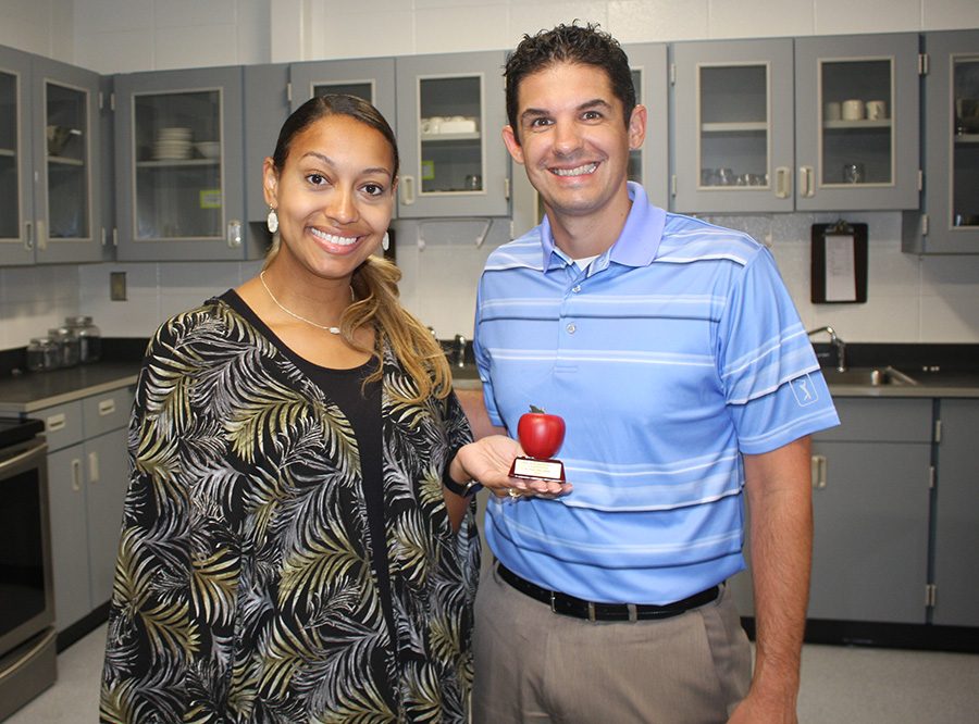 Tim Monihan from Farmers Insurance in Peachtree City poses with this month’s Golden Apple winner Adriah Williams. “Students are people and teachers are people, and I think I’m drawn towards the teaching profession because I am a people person,” Williams said. 