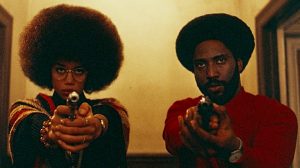 Ron Stallworth (John David Washington) and Patrice Dumas (Laura Harrier) stand with weapons drawn during the film’s finale. “BlacKkKlansman” is cinematically near-perfect and politically complicated.