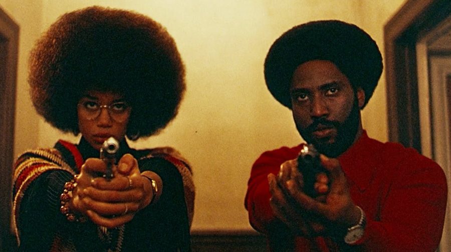 Ron+Stallworth+%28John+David+Washington%29+and+Patrice+Dumas+%28Laura+Harrier%29+stand+with+weapons+drawn+during+the+film%E2%80%99s+finale.+%E2%80%9CBlacKkKlansman%E2%80%9D+is+cinematically+near-perfect+and+politically+complicated.