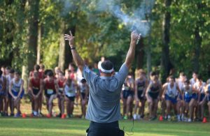 Chad Walker fires the pistol to signal the beginning of the varsity boys race at the 7th Annual AT&T Panther Invitational held at Heritage Church on Sept. 1. Starr’s Mill varsity boys placed first at the home meet with a total of 72 points and an average 5k time of 16:52. The varsity girls took home the second place title after finishing in an average race time of 20:18 with a total of 73 points, 36 points behind first place Auburn.