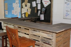 One of the high tables history teacher Jason Flowers made for his new flexible classroom. The tables were made from extra pallets left after the summer renovation. The seating allows the students to learn in an informal setting.