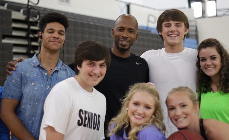 Gibbons (middle) poses with students from a team sports class.