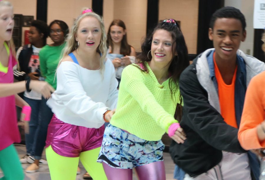 Sept. 20, 2018 - Group of seniors dances around the rotunda on decades day. For decades day during Homecoming Week, the seniors represent the 1980s, carry around speakers and start dance parties in the rotunda and around the attendance office. 