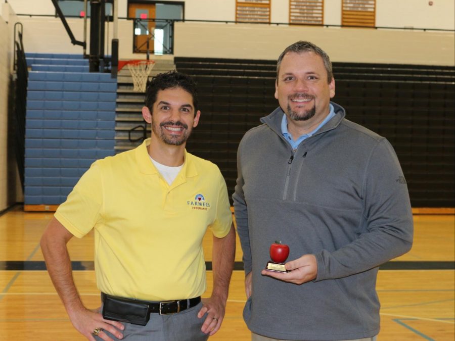 Tim Monihan from Farmers Insurance in Peachtree City poses with this month’s Golden Apple winner Jason Flowers. Flowers was selected for this award because of his personable  teaching style, which helps him relate to his students.