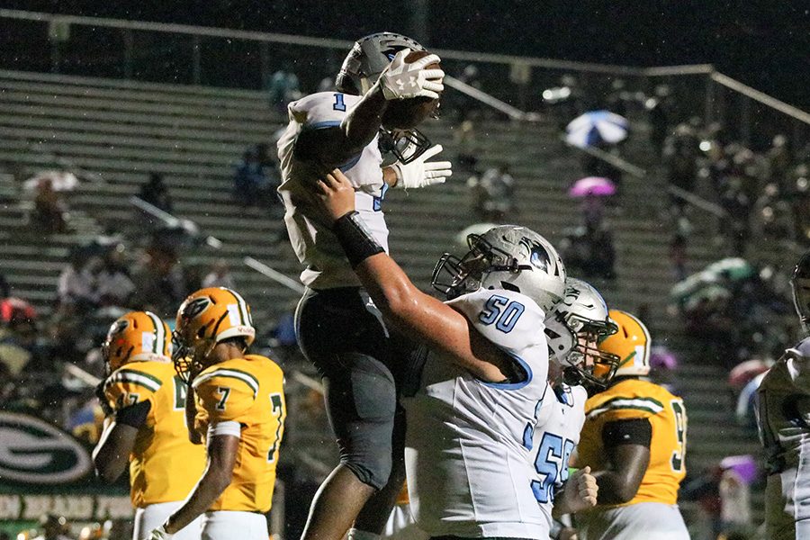 Junior Jeff Tiller raises up junior Kalen Sims as the two celebrate a touchdown. Sims rushed for 145 yards and two touchdowns against the Bears. He now has 842 yards and nine touchdowns on the season. 