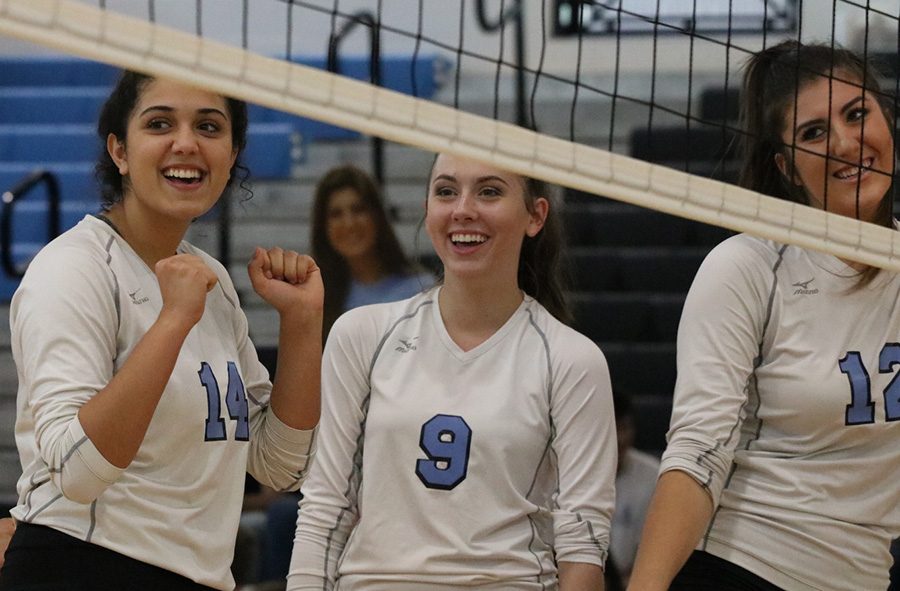 Three members of the Mill smiling after a win in a best-of-five match against Westlake. They beat the Westlake Lions 25-7 in all three games. “I love being with everyone and seeing everyone grow and develop as a team,” senior Lauren Ratinaud said.  “When we work together and when we talk, we’re such a good team and everyone plays so well.” 