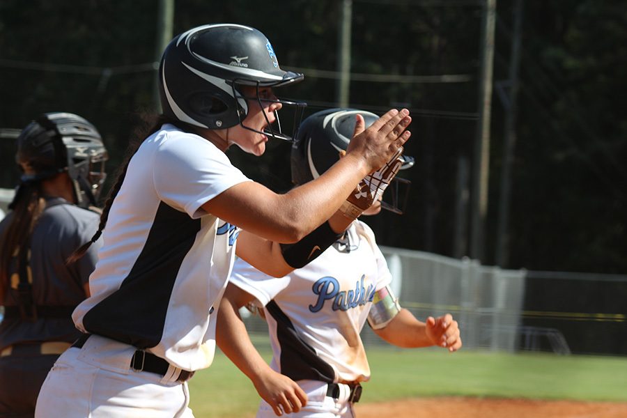 Senior Alyssa Angelo and sophomore Lauren Flanders celebrate during the Lady Panthers’ 8-3 win the first game of the series. Senior Kate Ashmore and freshman Lilli Backes each recorded three RBIs in the Mill’s win over Wayne County.