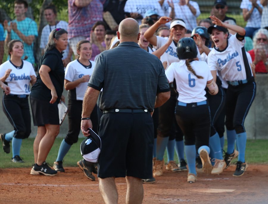 The Lady Panthers celebrate a home run from sophomore Jolie Lester. The home run was one of many runs scored in the Mill’s 10-1 win over Wayne County.