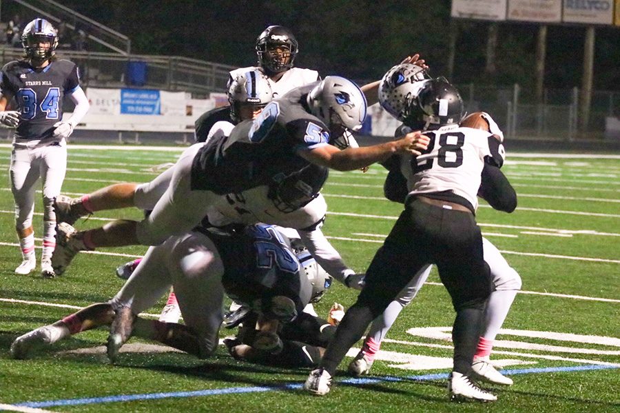 Junior Jaxon Via leaps at junior Raider Chris Giles. The Panther defense allowed over 300 yards, but forced four turnovers and limited Riverdale to 22 points.