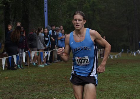 Senior Nick Nyman runs to the finish line. Nyman finished first in the boys’ varsity race. The Panthers finished in second place in varsity competition.