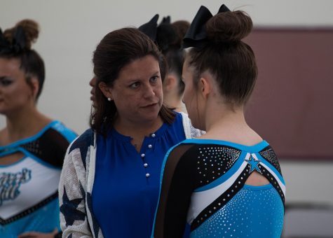 Head coach Heather McNally talks with senior Hannah Defler at the competition held at Whitewater High School where the Lady Panthers placed first.  “Definitely the best experience was hitting our routine at Whitewater because we got our confidence in, and it’s helped us throughout the the season,” Defler said.