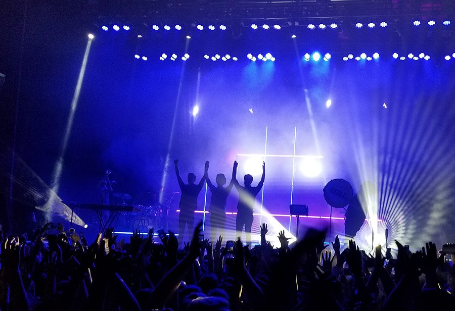 As their show comes to a close, the techno indie-pop trio AJR prepare to take a bow for their cheering audience. Their Atlanta concert, which took place on Halloween, was a magnificent display that featured the talent of Robert Delong as the opening performance.