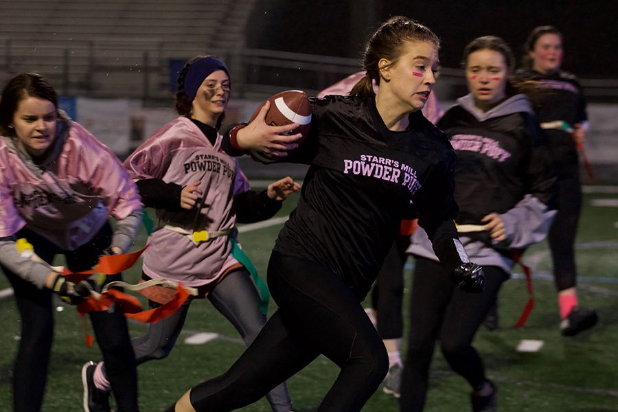 Senior Shelby Foster pulls the flags off of junior Miyah Hunter. The class of 2019 played the class of 2020 in the Starr’s Mill Powderpuff game for Promise Place. The game raised over $2000 for Promise Place.