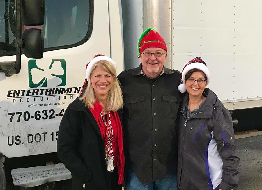 Kathy Gloer (left) and Sandi Donaldson (right) pose with the driver of a truck filled with toys and supplies. On Dec. 11, Gloer ventured to the coast of Florida in an effort to save Christmas for children impacted by Hurricane Michael.