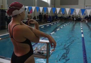 Freshman Caroline Walton stretches before her 500-yard freestyle at the Lakeside Invitational swim meet on Dec. 1. The girls swim team placed first out of 17 teams and the boys placed fifth out of 17 teams. The Lakeside High School men’s swim team took first for men’s. Starr’s Mill placed second overall, with Lakeside taking the win.