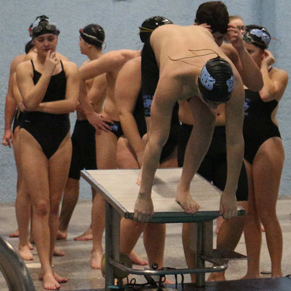 Sophomore Hayden Wiberg practices his dive during warm ups. Wiberg placed third in both the 200-yard freestyle and the 100-yard backstroke.