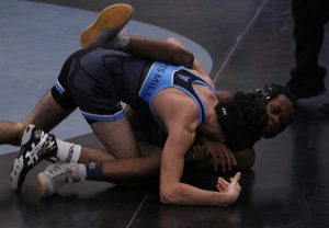 Freshman Nick Ferraro struggles for position against a Jonesboro opponent. Ferraro, in the first match of the day, got the Panthers started on their shutout win. “We’re looking for [the younger guys] to do their jobs,” head coach Andrew Garner said. “Whether that is to get a win, get a pin, or if they don’t win, to not get pinned.”