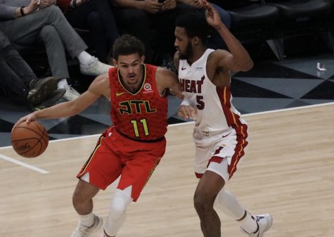 Miami Heat forward Derrick Jones Jr. defends against Atlanta Hawks rookie guard Trae Young.  The two led their respective teams in scoring. Young led the Hawks with 19 points, and Jones contributed 14 for the Heat. The 106-82 win was the third time this season the Hawks defeated the Heat.