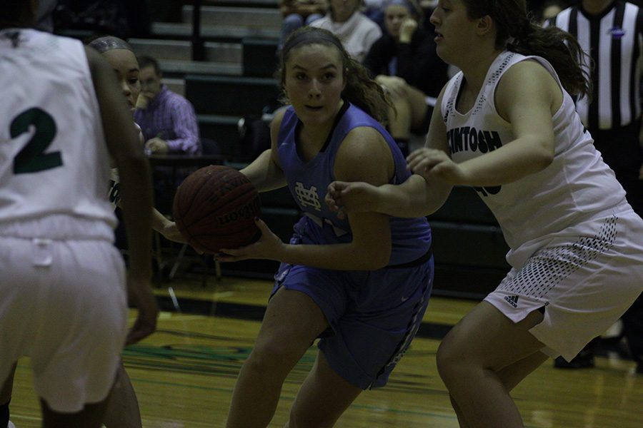 Junior Ryanne King looks for a layup in the paint. The girls won both games of their region doubleheader, beating McIntosh 85-61 after being down 11 in the fourth quarter, and defeating Whitewater 61-55 in double overtime. The boys split their games, losing to McIntosh 85-61, and beating Whitewater 46-34. 