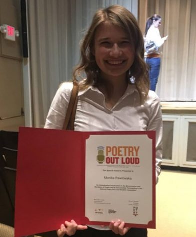Junior Monika Pawlowska holds a certificate after the Poetry Out Loud school competition. In the competition, students had to memorize two poems from a given list and recite them in front of a panel of judges. 