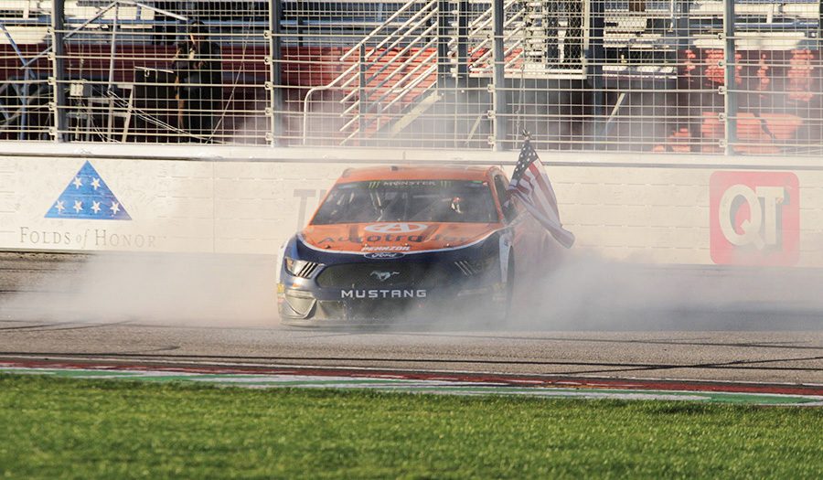 Brad Keselowski flies an American flag following his second career win in Atlanta. Keselowski spent most of the race shifting positions throughout the top-10, but his mistake-free driving allowed him to take the lead for the final 33 laps of the race.