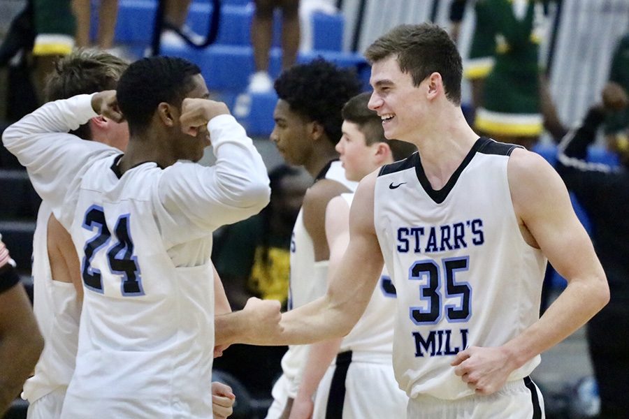 Senior Nate Allison celebrates with teammates during their matchup with Griffin. Allison passed the 1,000 career point mark against the Bears, doing so on senior night and his birthday. Allison finished the game with 11 points and five rebounds.
