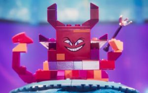 Queen Whatevra Wa’Nabi reveals her monstrous form after kidnapping Wyldstyle and Batman. This new character represents the real-world little sister of the son in “The Lego Movie.”