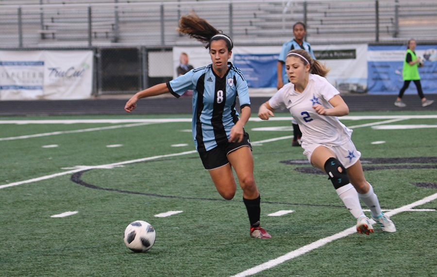 Sophomore Sofia Varmeziar chases a ball while Granger sophomore Malone Aldridge attempts to keep up. Varmeziar scored one goal, and she was a large contribution to the offense, making skilled passes that helped move the ball around the field.