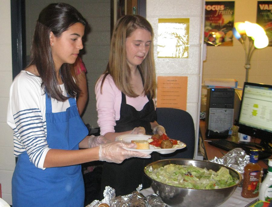 Family, Career and Community Leaders of America students serve pasta during the Mama Mia fundraiser. The dinner and themed basket silent auction will help purchase supplies for the Starr’s Mill child development center.