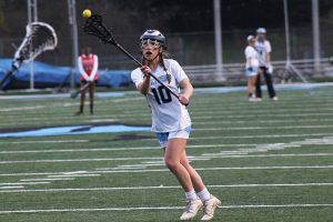 Sophomore Jacqueline Broderick looks to pass the ball. Good passing and communication allowed the Lady Panthers to blow out Dutchtown 19-1 for their first win of the season. The Mill’s offense overpowered the Lady Bulldogs’ weak defense by breaking down the field fast, and winning the majority of the face-offs to keep the ball on Dutchtown’s side of the field. 