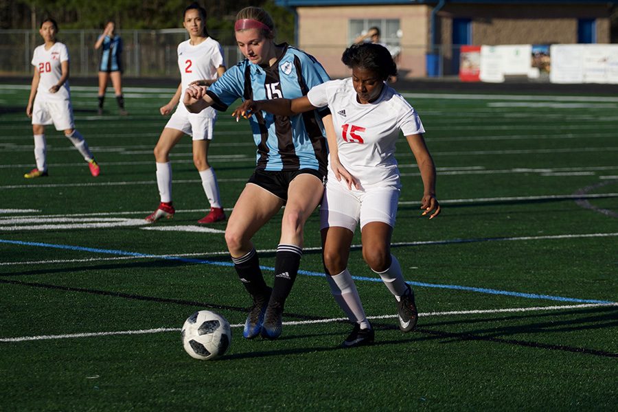 Junior Kara Dial fights for the ball against a Jonesboro opponent. Dial had two goals in the game against the Cardinals. The Mill dominated the game as Jonesboro struggled to keep up with the Panther offensive strides.