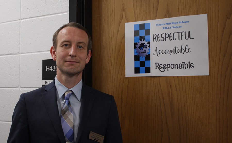 Assistant principal Scott Robinson pictured next to one of the PBIS (Positive Behavioral Interventions & Support) posters. For Starr’s Mill, PBIS will really be about emphasizing what our school culture is and what values us panthers represent.