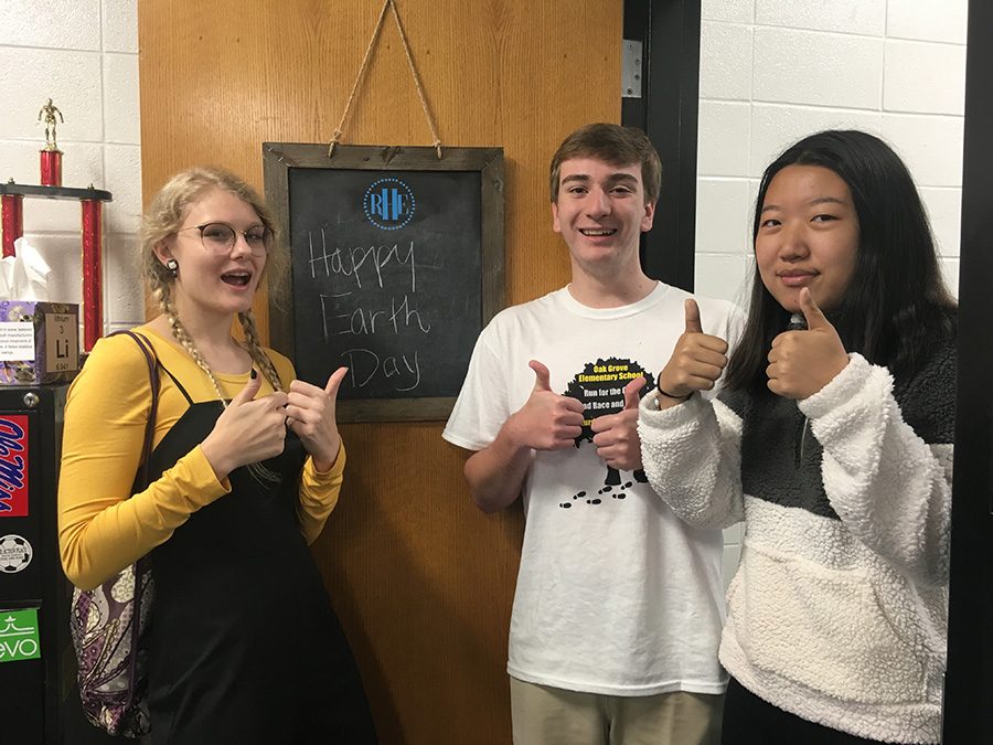 Eco Club members and juniors Brock Spence, Jackson Van Huffel, and Rebecca Tian celebrate Earth Day. The club is organizing a bingo game to promote environmental awareness.