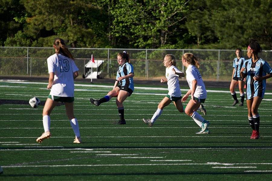 Senior Rachel Davison kicks the ball while two defenders attempt to get control of the ball. Davison scored her only goal in the 52nd minute of the second half. The Mill then went on to score three more goals.