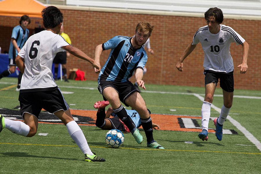 Senior Jack Baker runs the ball down the field with a McIntosh player trailing. “We’ve just really come together and we’ve really come to play like a team,” Pavel said. “In the start of the season we had two red cards and some injuries, but as we recollected and we came back together I really think we finished strong.”