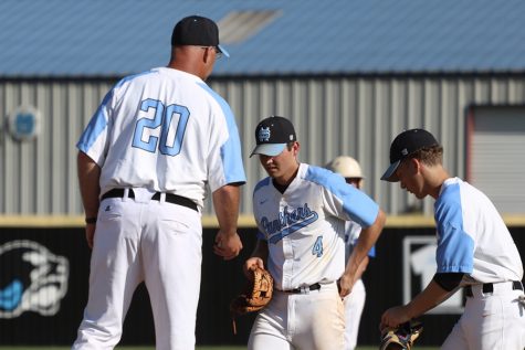 Head coach Brent Moseley talks with senior Brian Port and junior Beau Gardner at the mound during game three. In a series-determining game, the Panthers were unable to pick up the win, bringing an end to their season in the second round of the state playoffs despite winning a third straight region title.