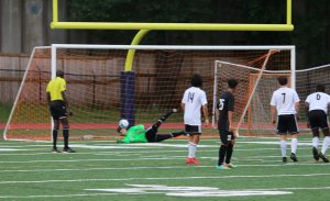 Senior Michael Lantz saves an attempted goal off a penalty kick. Lantz was a big part in the 2-0 win, saving all eight shots on goal by the Indians. With this win, the Panthers have yet to be scored on in the postseason, outscoring their opponents 14-0.