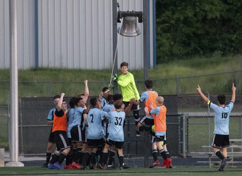 Senior Michael Lantz rings the victory bell as the rest of the team celebrates. The Panthers defeated Johnson 2-0 after losing to them 4-0 in the Final Four last year. This win sets up a Battle of the Bubble against McIntosh for the AAAAA GHSA State Championship.