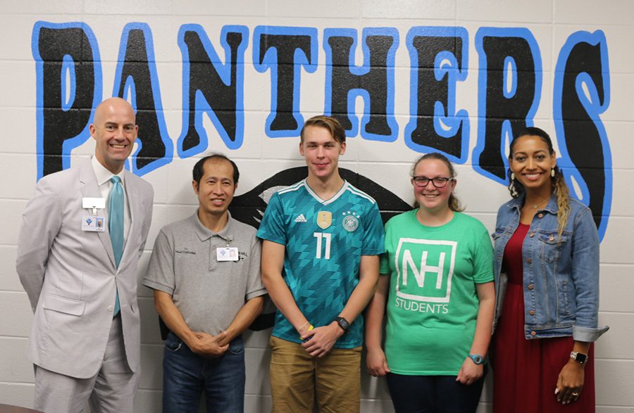 Principal Allen Leonard and teacher Adriah Williams stand with custodian Tri Ha, senior Zach Livsey, and freshman Courtney Mckenna. They were chosen as the first PBIS faculty member and students of the month. 