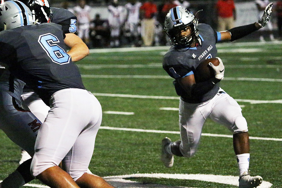 Senior running back Kalen Sims drives the ball down the field against Mt. Zion. The Panthers used a strong defense to limit the Bulldogs to only one touchdown, while running the ball constantly on offense.